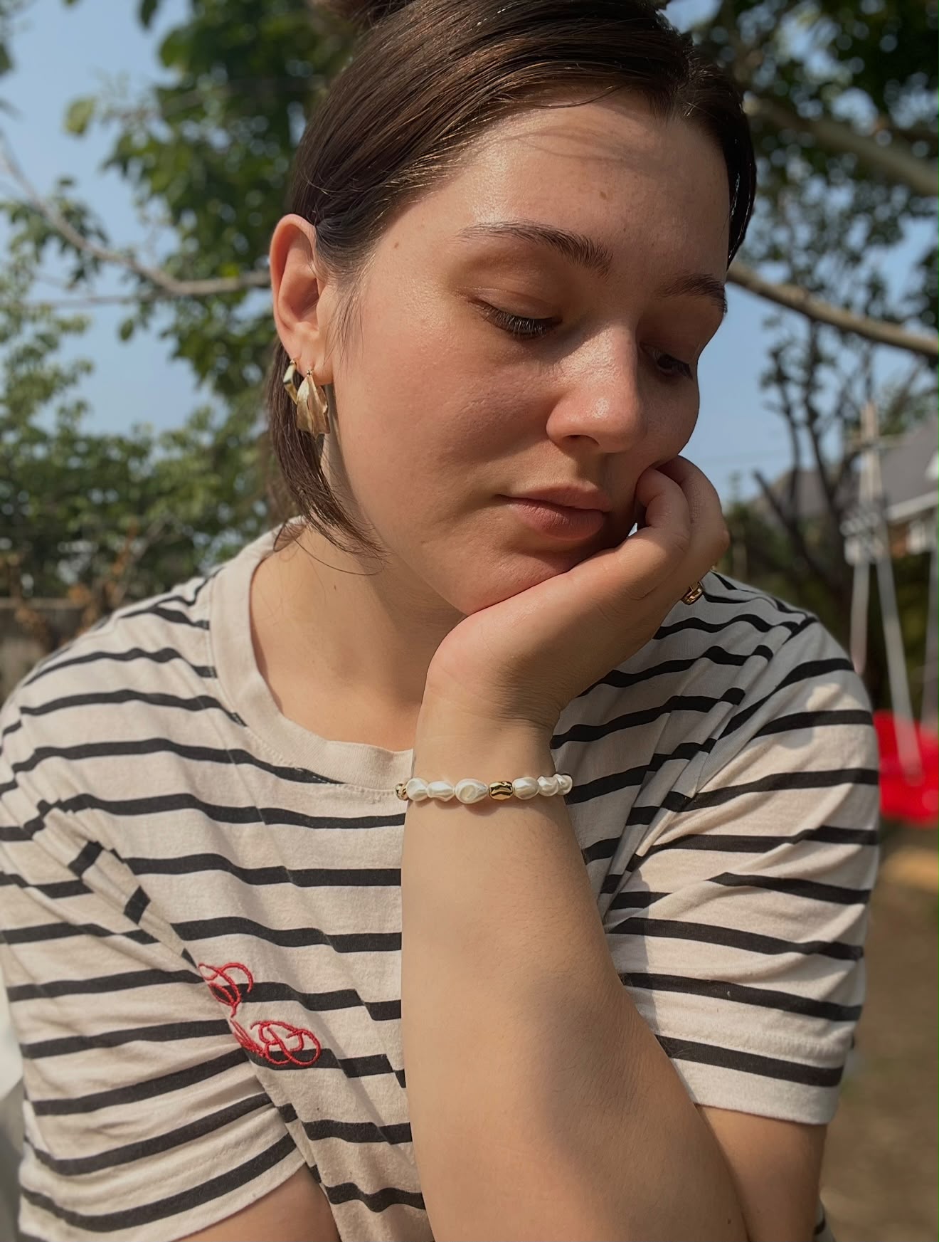 EVN Jewellery customer wearing gold earrings and the pearl bracelet