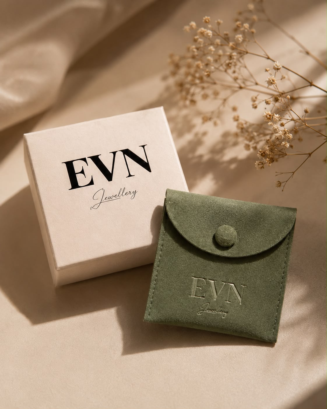 EVN Jewellery cream gift box and forest green pouch arranged for the press book.
