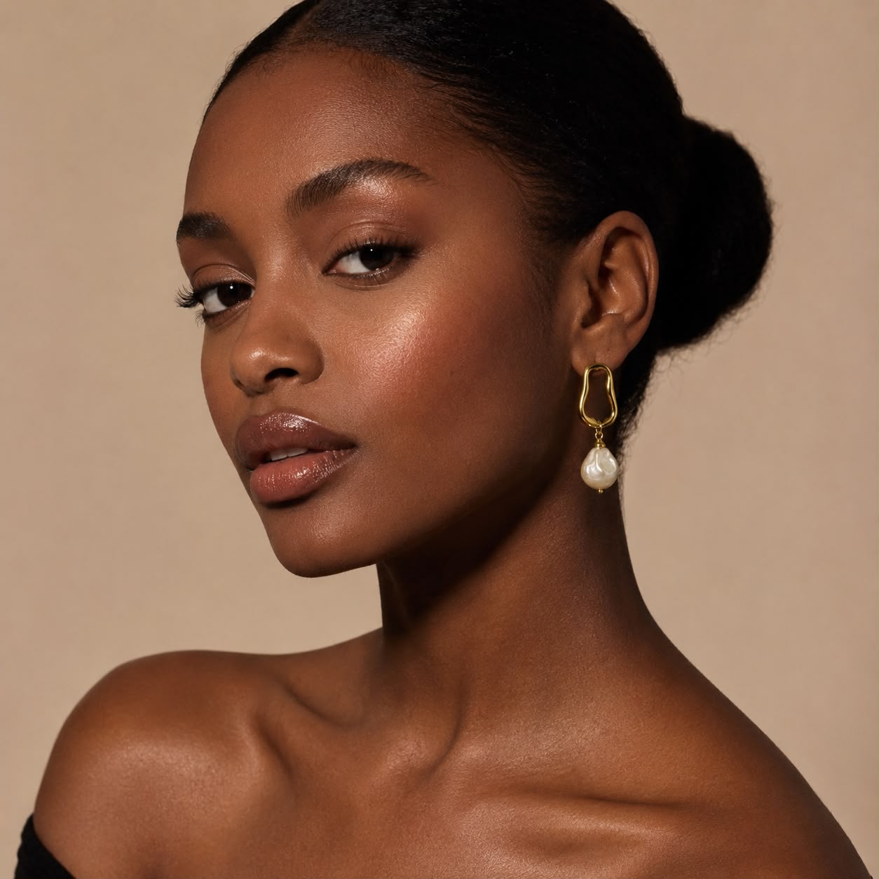 Side detail of the gold-tone frame and glass pearl drops